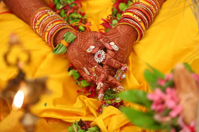 Midsection of woman wearing jewelry during wedding ceremony