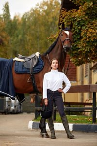 Low section of man riding horse in park