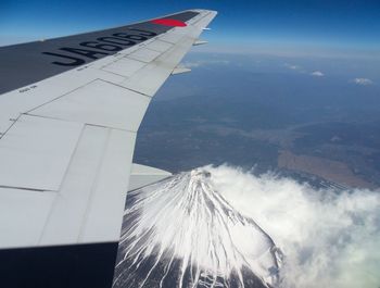 Low angle view of airplane wing against sky