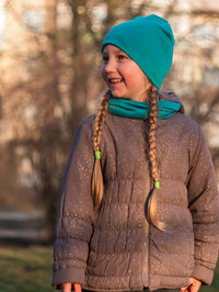 Happy girl with long hair portrait in spring park on tree sunset outdoor. family leisure on open air