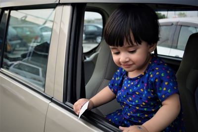 Girl looking through car window