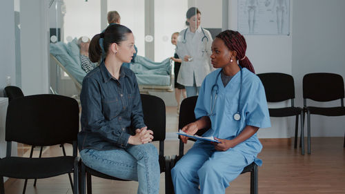 Nurse talking with patient at hospital