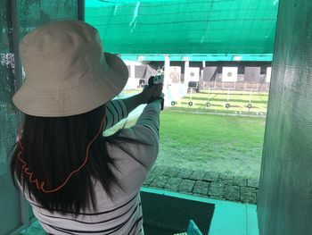 Rear view of woman photographing outdoors