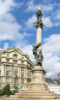 Low angle view of statue against cloudy sky