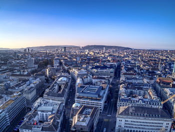 High angle view of city buildings against clear sky