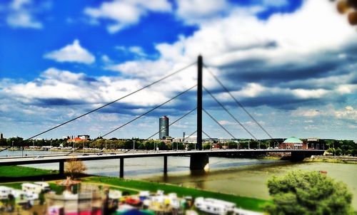 Suspension bridge against cloudy sky