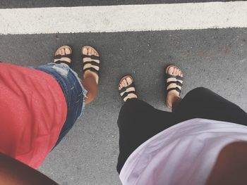 Low section of people standing on road