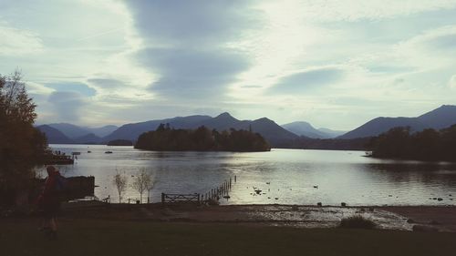 Scenic view of lake against cloudy sky