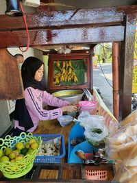 Woman for sale at market stall