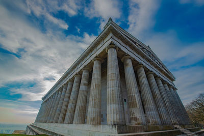 Low angle view of historical building against cloudy sky