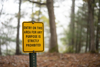 Yellow warning sign on post in wisconsin state park, entry is strictly prohibited