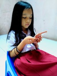 Full length of woman using mobile phone