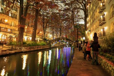 People walking in illuminated city