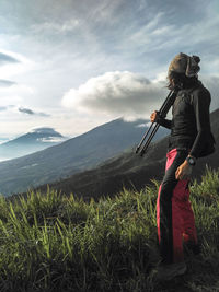 Man standing on mountain against sky