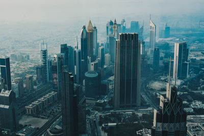 High angle view of modern buildings in city against sky