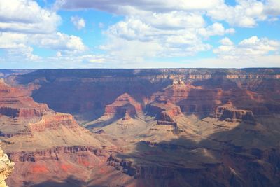 Aerial view of dramatic landscape against cloudy sky