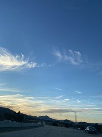 Road against blue sky during sunset