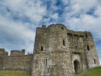 Low angle view of historic building against cloudy sky