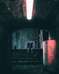 Woman standing in abandoned building