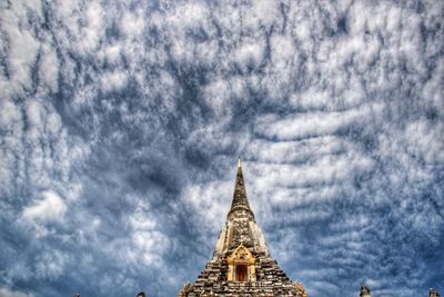 Low angle view of building against cloudy sky