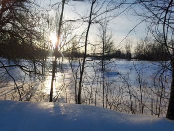 Scenic view of frozen lake against sky during winter