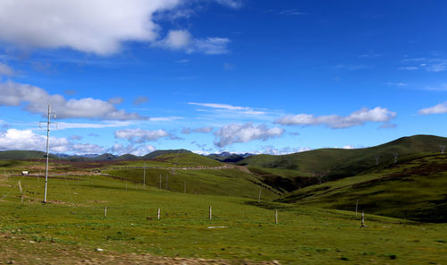 Scenic view of landscape against blue sky