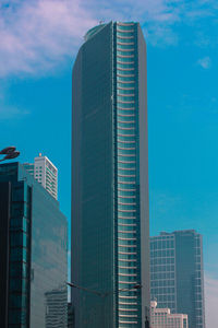 Low angle view of modern buildings against blue sky