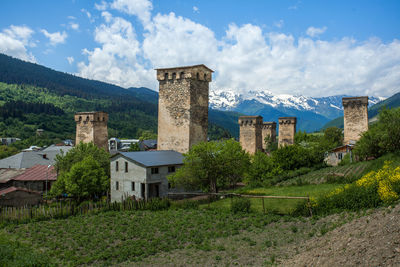 Buildings against sky with trees in foreground