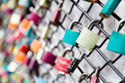 Close-up of padlocks on fence