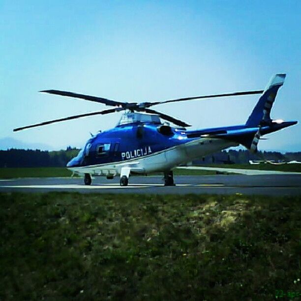 transportation, mode of transport, blue, clear sky, air vehicle, airplane, grass, flying, field, landscape, copy space, travel, mid-air, on the move, outdoors, sky, day, nature, journey, no people