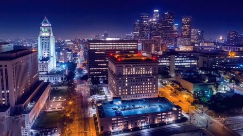 High angle view of illuminated buildings in city at night