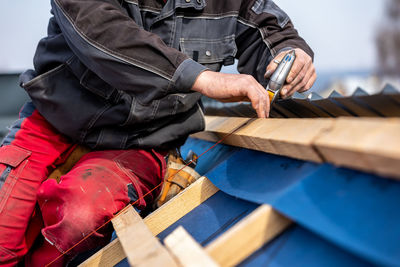 Midsection of man working in workshop