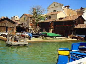 Boats moored on shore against clear sky