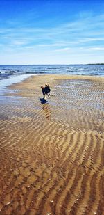 Man on beach against sky