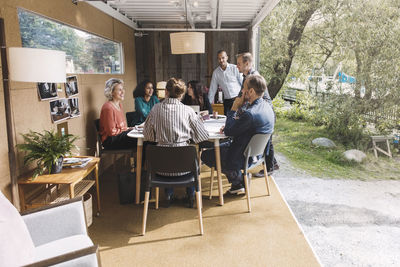 Business colleagues discussing strategy in portable office truck