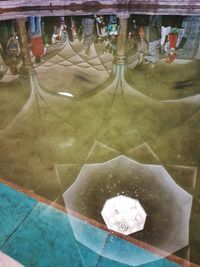 High angle view of wine glass in swimming pool