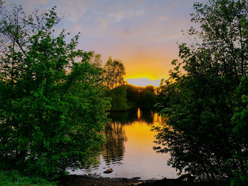 Scenic view of lake against sky during sunset