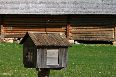 Old wooden house on field