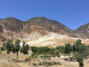 Scenic view of mountains against clear blue sky