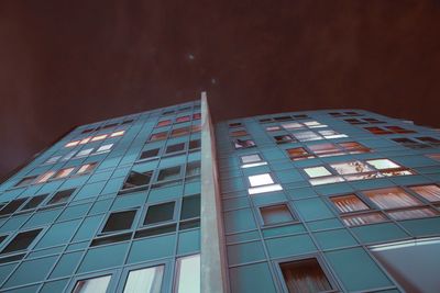 Low angle view of modern building against sky at night