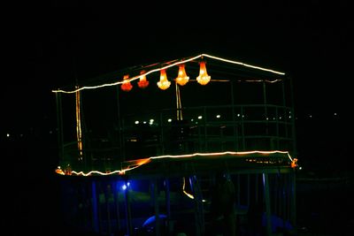 Illuminated lighting equipment against clear sky at night