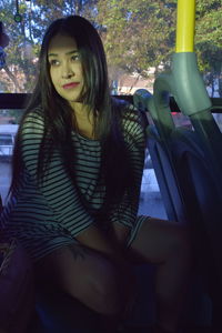 Portrait of young woman sitting in car