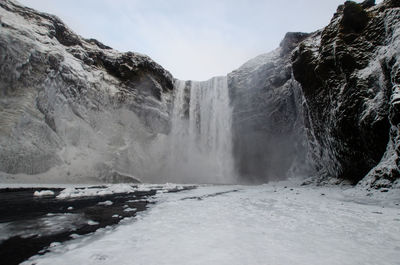 Scenic view of waterfall against sky