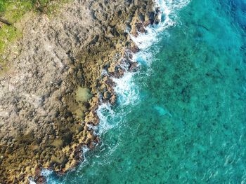 Aerial view of rocks on sea shore