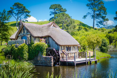 House by lake against building