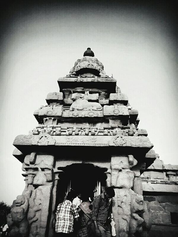 low angle view, built structure, architecture, clear sky, building exterior, place of worship, religion, spirituality, steps, sky, history, temple - building, roof, old, day, copy space, outdoors, stone material, sunlight