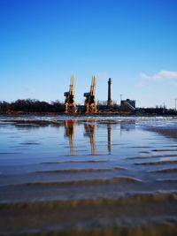 Reflection of built structure in the baltic sea against blue sky