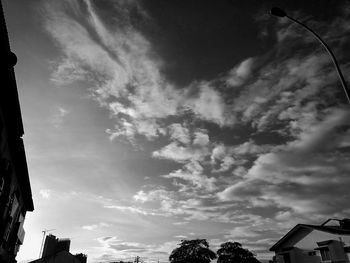 Low angle view of building against cloudy sky