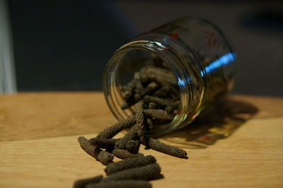 Close-up of glass jar on table with pepper