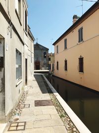 Empty alley amidst buildings in city